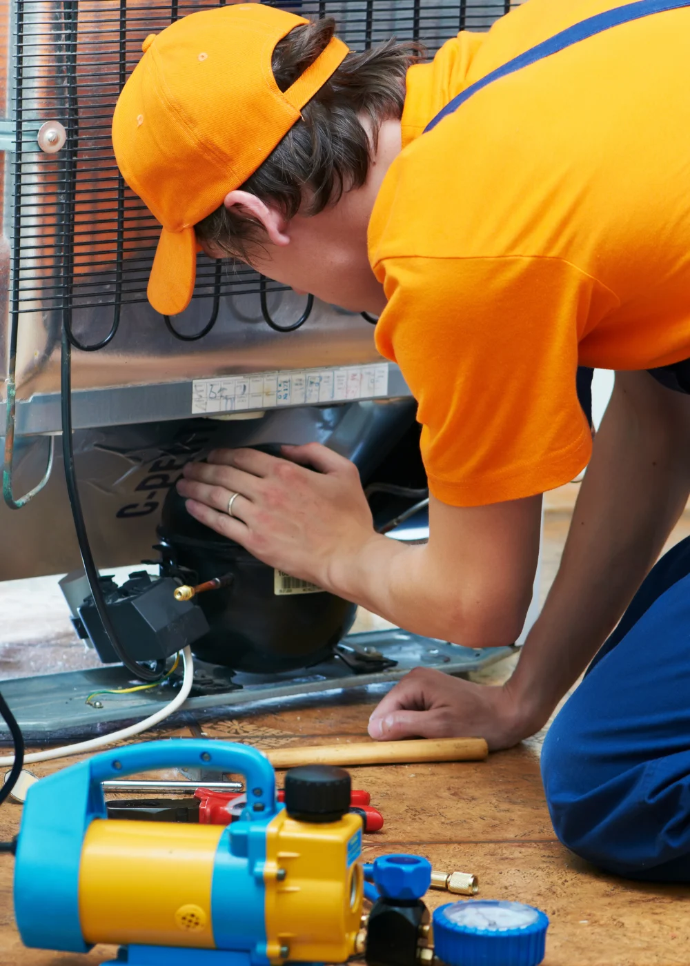 Engineer working on a commercial fridge